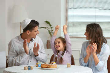 Happy family celebrating Hannukah at home