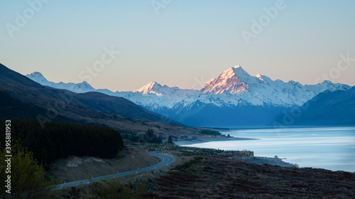 Mount Cook road and snow-capped mountains in the background along the shoreline of Lake Pukaki, South Island, New Zealand