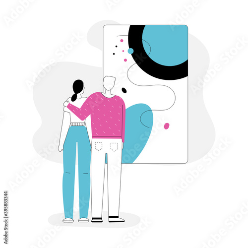 Man and woman hugging and looking at abstract painting