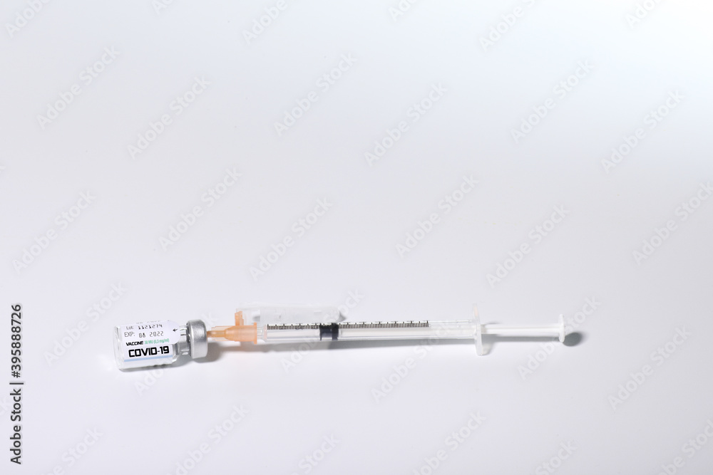 Covid 19 vaccine bottle and syringe with white background