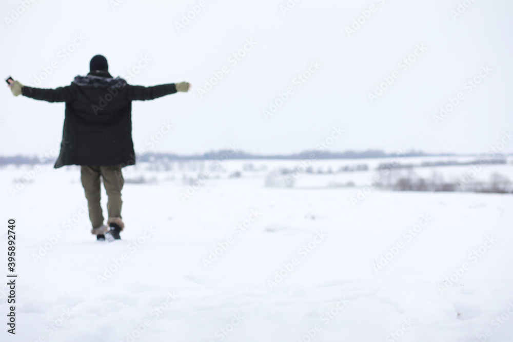 Bearded man in the winter woods. Attractive happy young man with beard walk in the park.