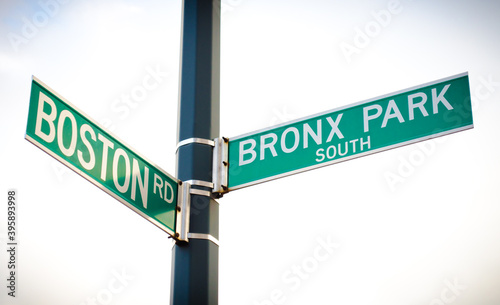 New York City Green Street Signs. Boston Road and Bronx Park South intersection. Low Angle View, Cloudy Sky in background. Manhattan, New York, USA.