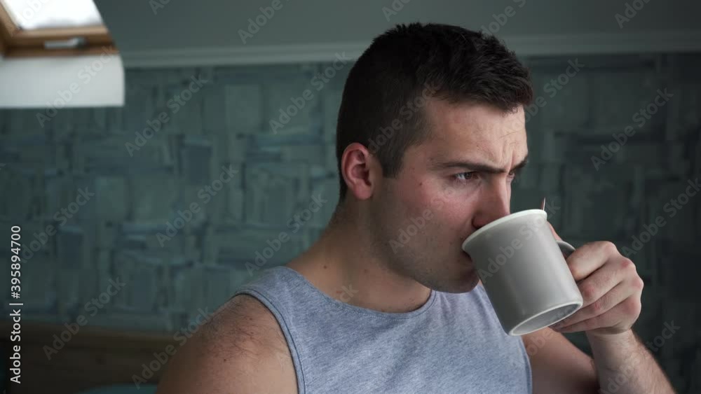 man drinking coffee standing by the window man drinking coffee standing by the window