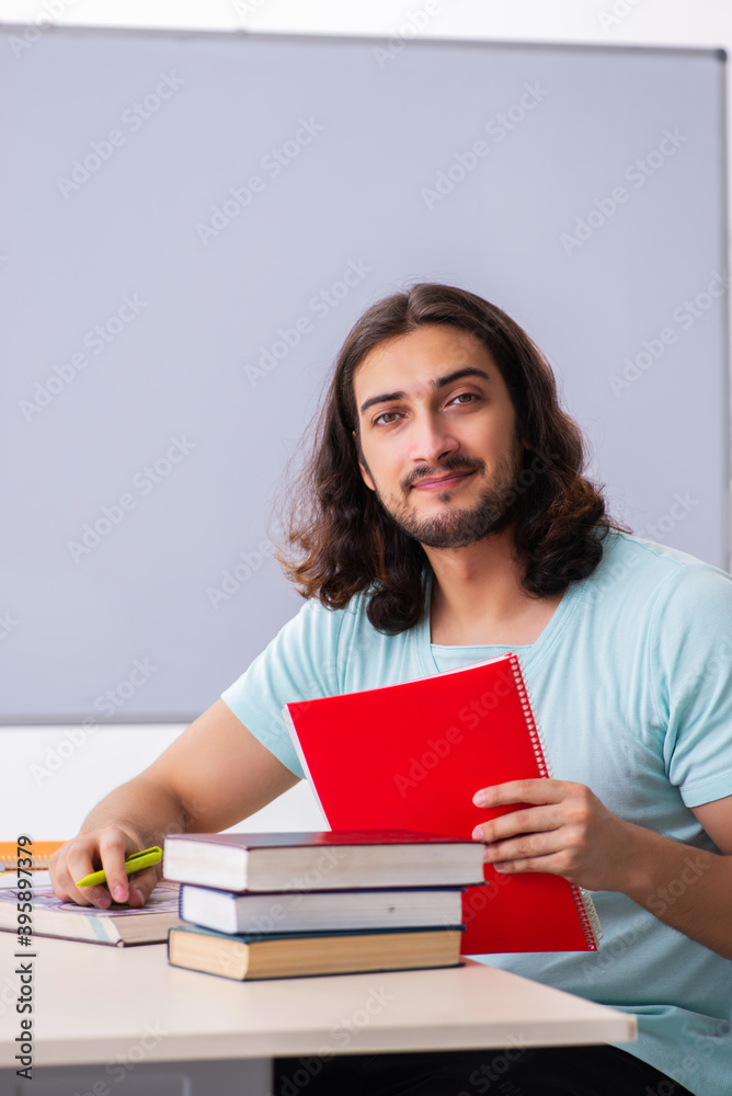 Young male student preparing for exams in the classroom Young male student preparing for exams in the classroom