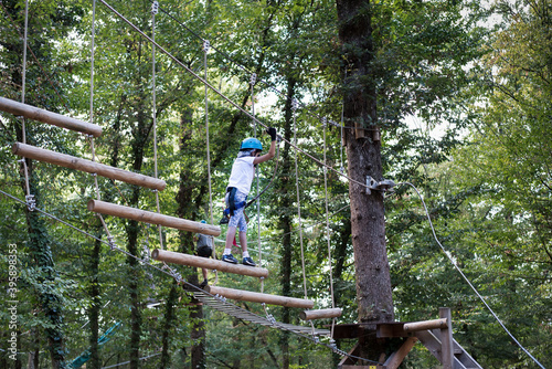 The girl in the adventure park. Obstacle course in the forest.