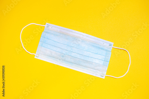 Medical protective face mask  on yellow background