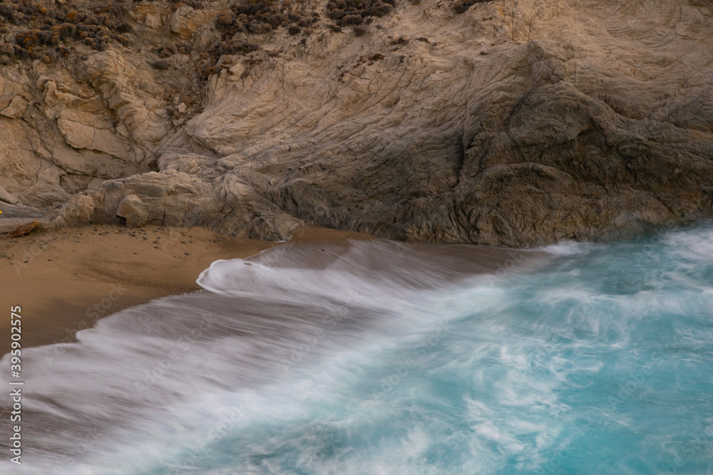 Long exposure image of shore breaking waves on the beach of Nas, Ikaria