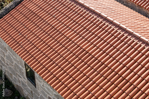 High angle view of a new roof made of traditional clay tiles. Old architecture