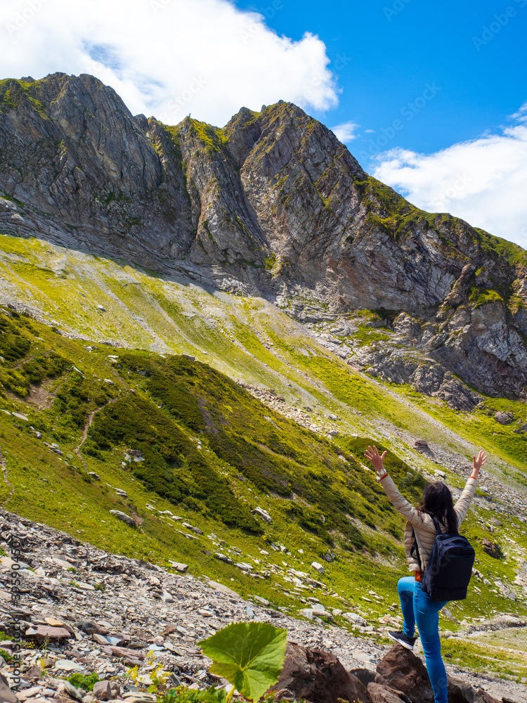 Unity with nature. Hiking in the mountains. Young woman traveling in the mountains,