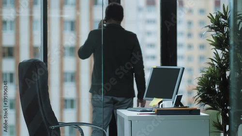 Fashionable interior of the office of the chief sales Manager, answering the phone against the background of panoramic Windows, the concept of office work