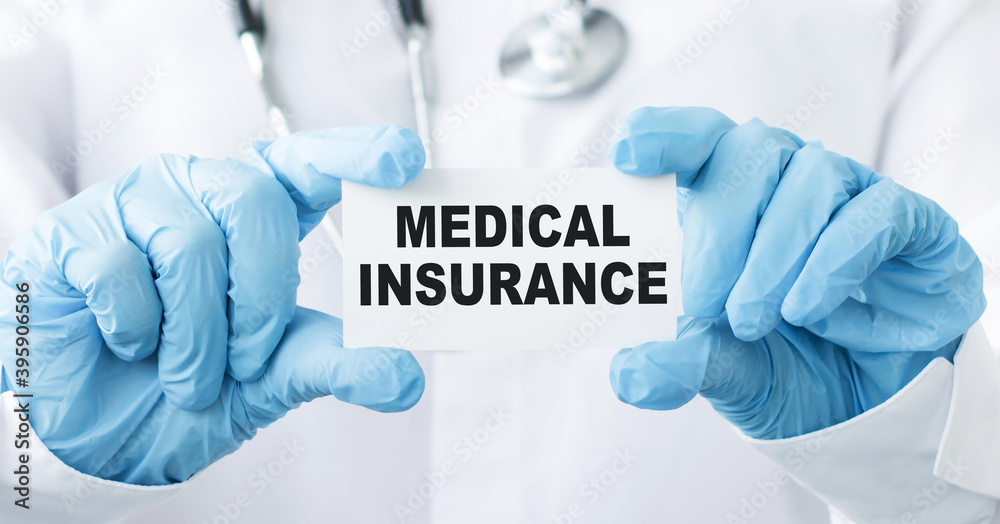 Doctor's hands in blue gloves shows the word MEDICAL INSURANCE. Medical concept. Doctor's hands in blue gloves shows the word MEDICAL INSURANCE. Medical concept.