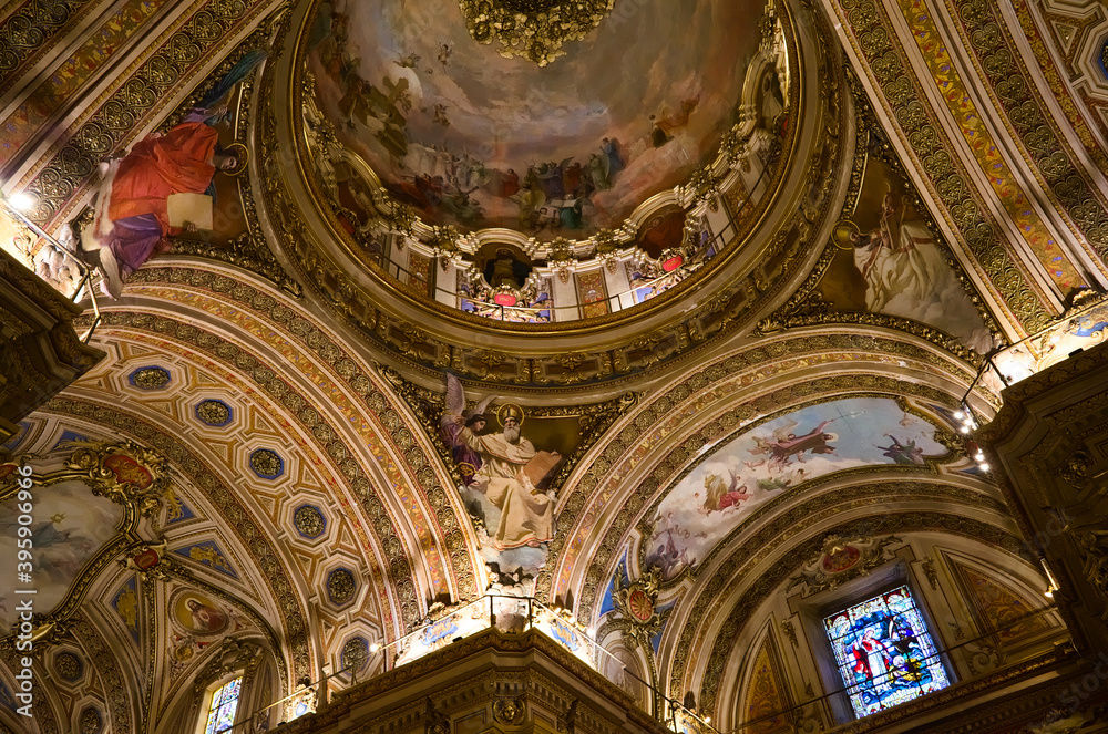 Cordoba, Argentina - January, 2020: Interior of Cathedral of Cordoba church ( Iglesia de Nuestra Senora de la Asuncion) . Painted ceiling fresco view of religions saints in Christianity.