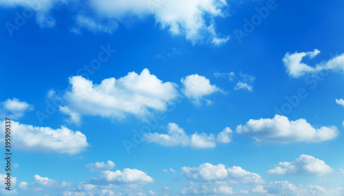 Sunny background, blue sky with white cumulus clouds 