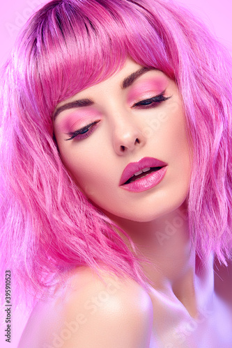 Beauty Fashion woman with Colorful Pink Dyed Hair. Girl with blue eyes, perfect Makeup and Hairstyle. Beautiful smiling model portrait, fashionable pink make up, hair. Skincare concept