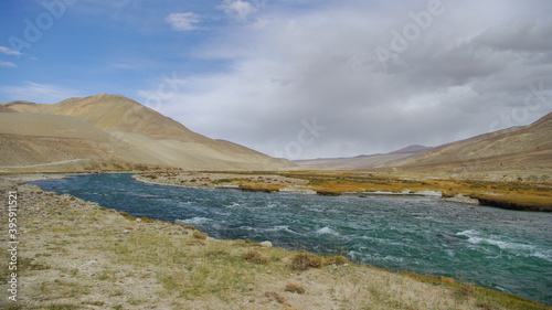 View of the Pamir river in the high desert between Langar and Khargush pass in Gorno-Badakshan, the Pamir mountain region of Tajikistan bordering Afghanistan