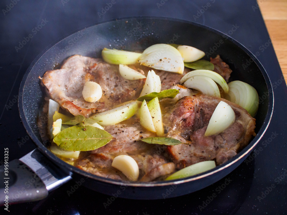 Pork steaks in frying pan with onion
Pork steaks in frying pan with onion