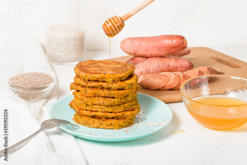 homemade autumn stack vegetarian pancakes with sweet potatoes and Chia seeds, low-calorie Breakfast, taking care of the body. watered with honey on a light background