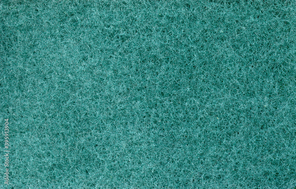 Fototapeta premium Texture of green dishwashing sponge. Abstract green background.