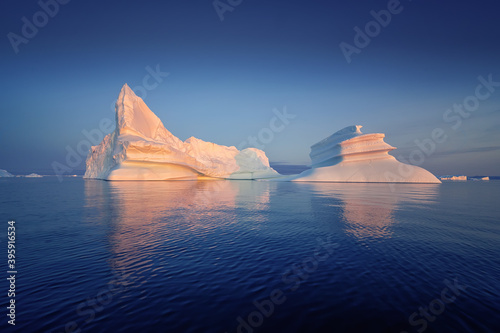 floating glaciers in the rays of the setting sun at polar night