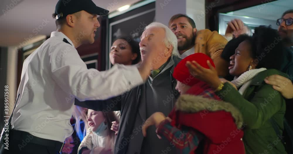 Security guard pushing crowd back during sale