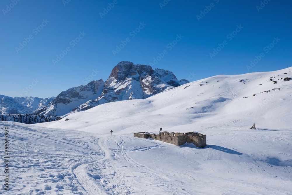 Mountain view with ruin of fort from World War I in winter sunny scenery, during climbing to Platzwiese (Piazza Prato) Strudelkopf Mountain. Dolomites, Italy