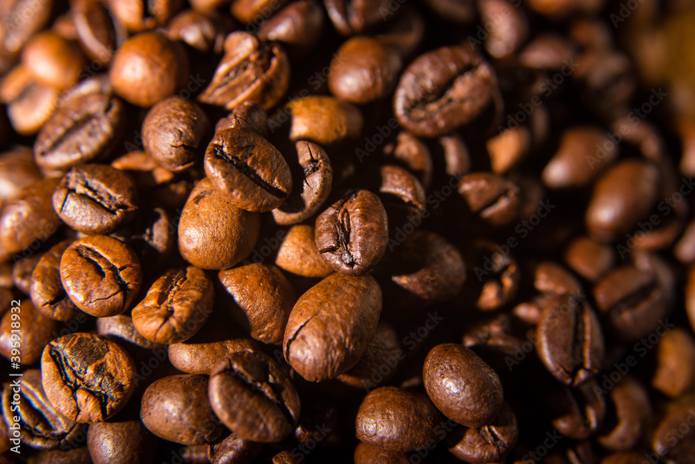 Fototapeta premium Roasted coffee beans on a silver background, close-up, space for text, Wallpaper, postcard, texture, background
