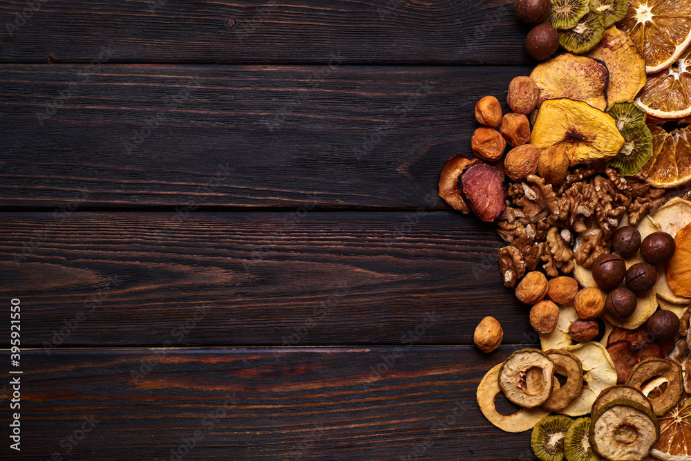 Mix of dried fruits and nuts on a wooden table