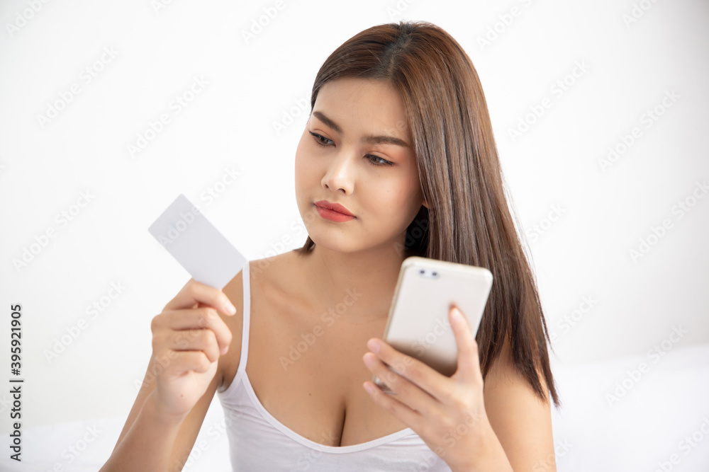 woman shopping at home with smartphone and credit card; concept of video call, shopping at home, tele shopping app or application, telemedicine VDO call, new normal social distancing