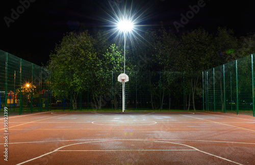 Empty basketball court in the night park