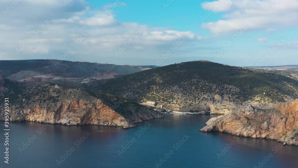 Flying toward bay above calm Black Sea, Sevastopol, Balaklava bay, Crimea Flying toward bay above calm Black Sea, Sevastopol, Balaklava bay, Crimea