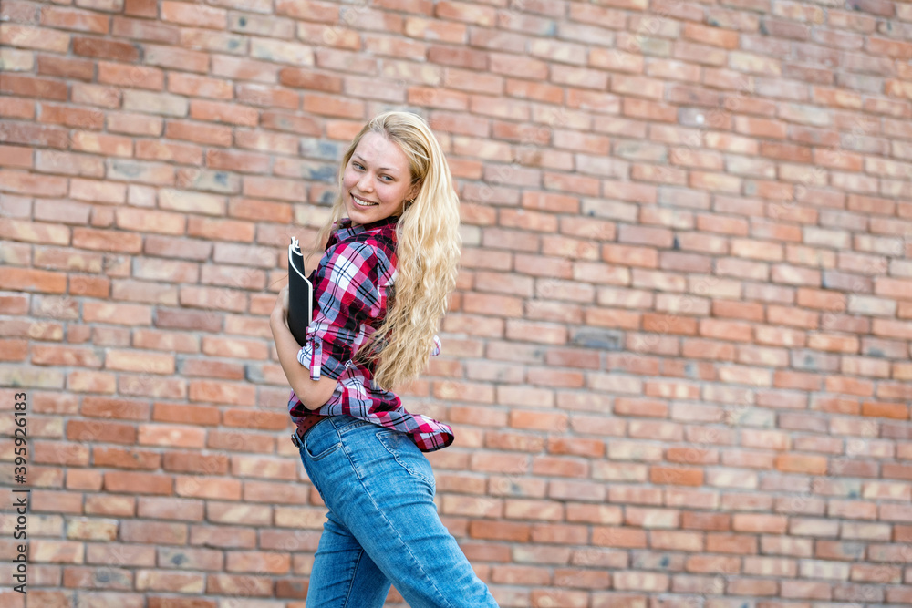 Adult academy student girl jumping with copybooks Adult academy student girl jumping with copybooks