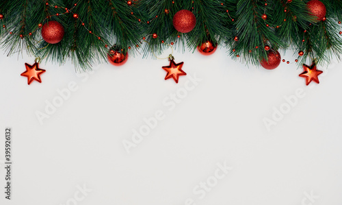 Christmas Border frame of tree branches with red decorations isolated on white. Christmas, New year, Festive background. Flat lay, top view, copy space..