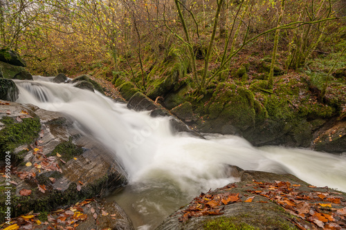 Long exposure of a waterfall on the Hoar Oak Water river at Watersmmet in Exmoor National Park in autumn photo