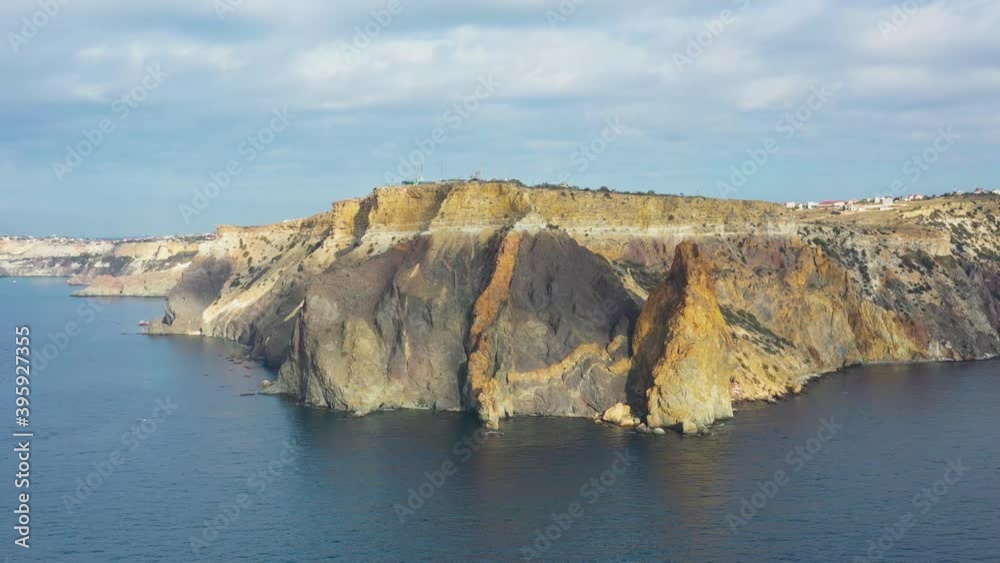 Flying toward coastline cliff above calm Black Sea, Fiolent cape, Crimea Flying toward coastline cliff above calm Black Sea, Fiolent cape, Crimea
