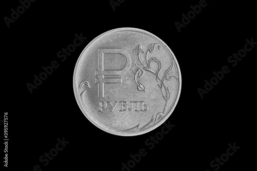 Metal coin of one russian rouble on black background. photo