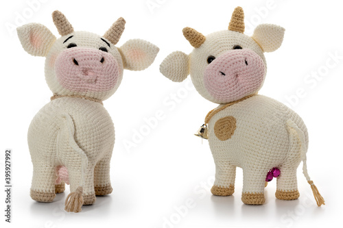 White bull and cow on a white background. Back view. Knitted toy. Full depth of field. With clipping path. © gna60
