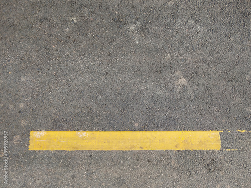Paved road background with yellow traffic lines