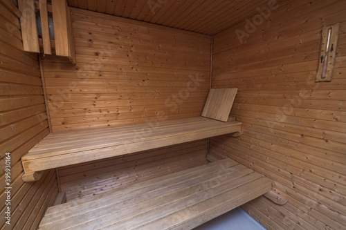 Close up view of sauna room interior. Wooden walls and seats. Health concept.