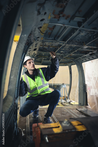 Portrait of a Caucasian man , factory engineer in work clothes controlling the work process at the helicopter manufacturer. 