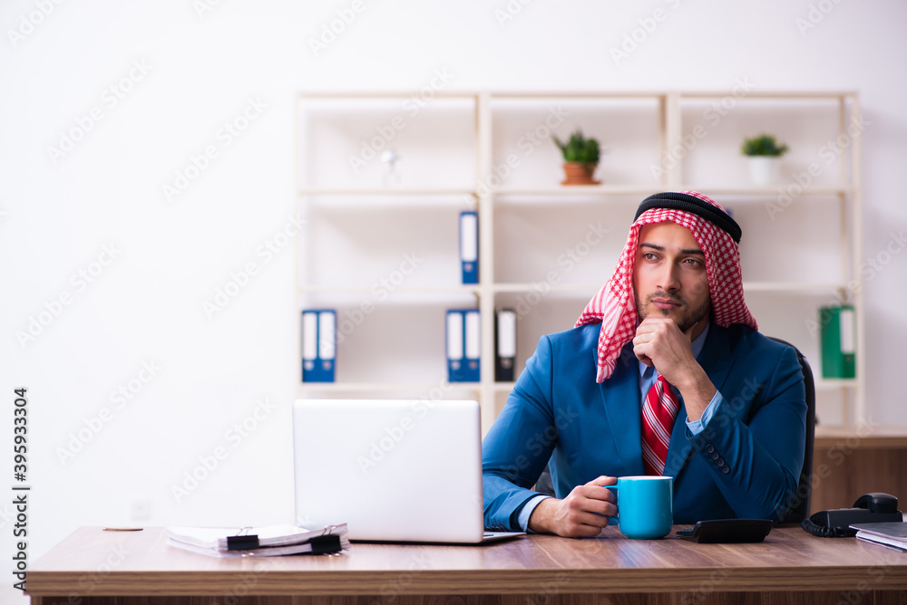 Young male arab employee working in office Young male arab employee working in office
