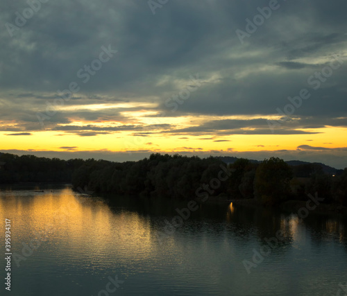 River under sunset light, clouds