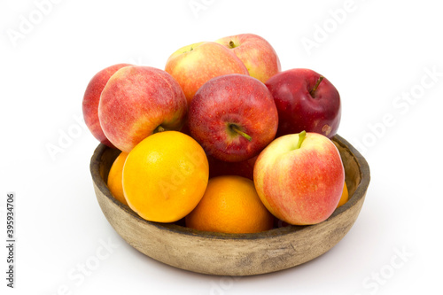 fresh fruits in a clay bowl - oranges and apples