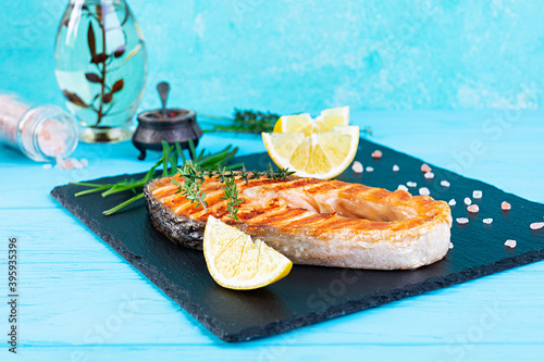 Grilled salmon fish on stone board. Salt atlantic salmon fried on grill with lemon