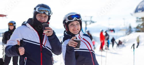 Portrait of smiling couple on skis in the mountains