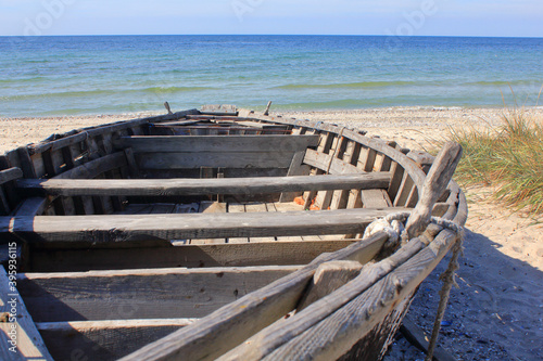 Old wooden boat on a deserted beach.