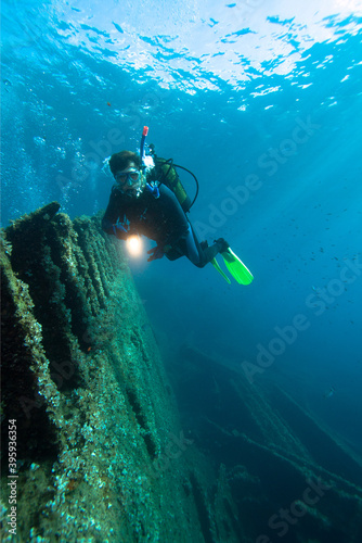 Diver exploreds the shipwreck.