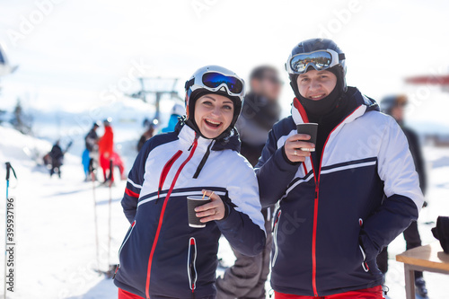 Portrait of smiling couple on skis in the mountains