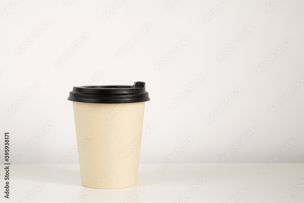 Coffee cup mockup on the white background. Empty cup on the table with copy space Coffee cup mockup on the white background. Empty cup on the table with copy space