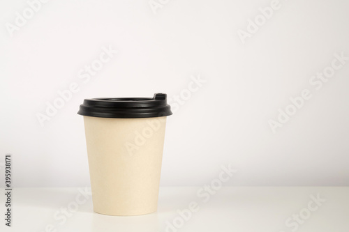 Coffee cup mockup on the white background. Empty cup on the table with copy space