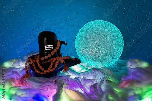 Black Shiva lingam figure in Divali lights with rudraksha beads 